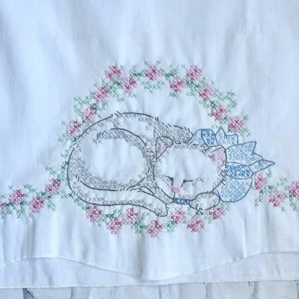 Cottagecore Cross-stitched or embroidered sleeping kitty on roses pillowcase